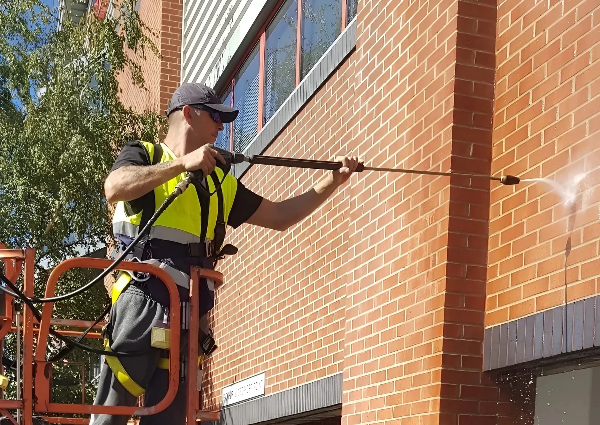 Jason from KJ Clean pressure washing a commercial building